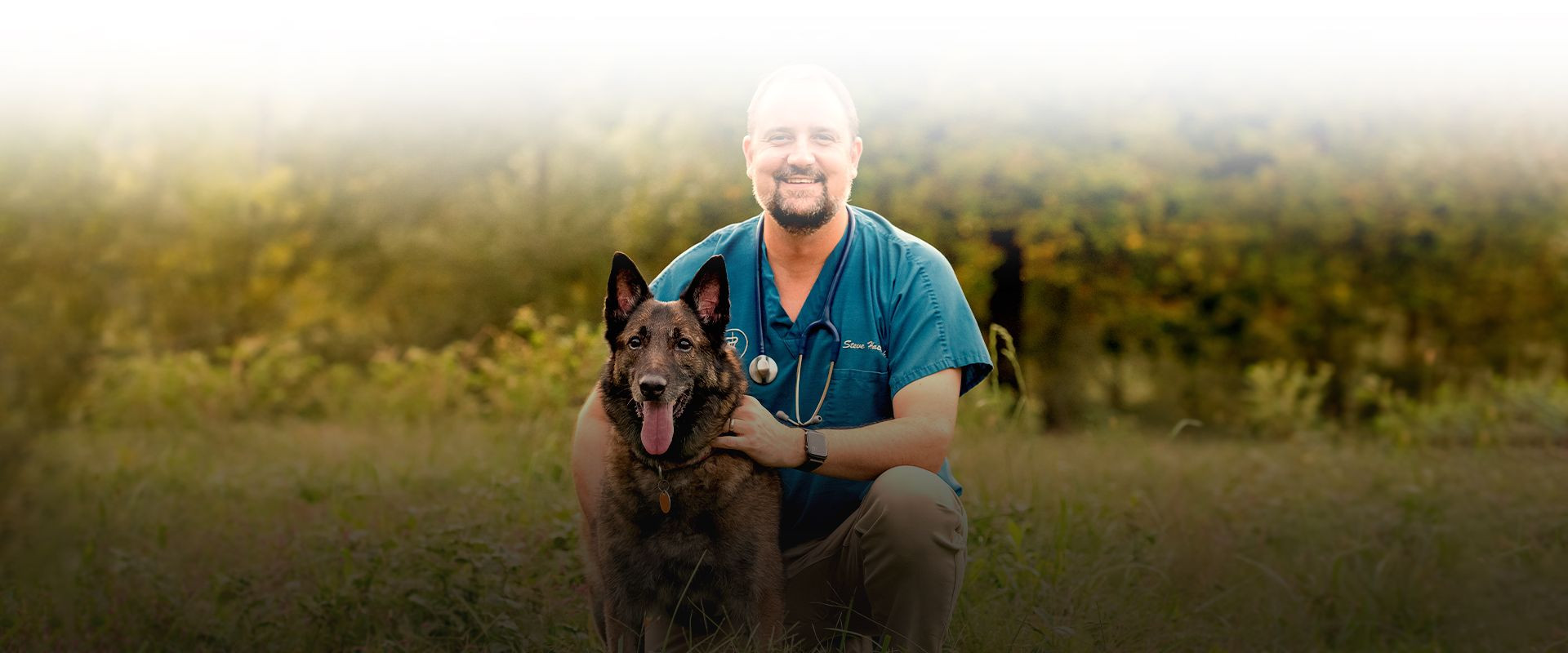 westside veterinary hospital veterinarian with his dog in nature
